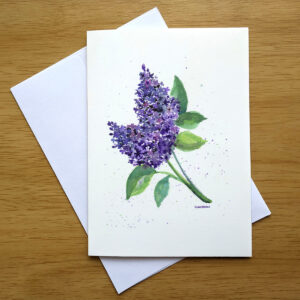 "Lilacs" painting by Kathleen Jackson is shown printed on the front of a greeting card